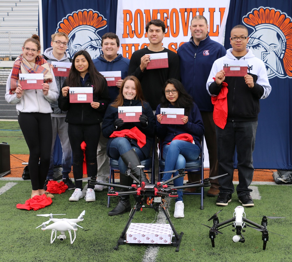 Romeoville High School students receive their college admissions acceptance letters from Lewis University via drone.