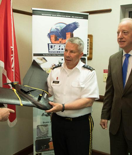 Semonite (left) assesses the features of the MRSD micro-dredge, which provides a rapid deployed, remotely operated dredging capability critical to navigation and port operations during emergency operations. Photo: USACE