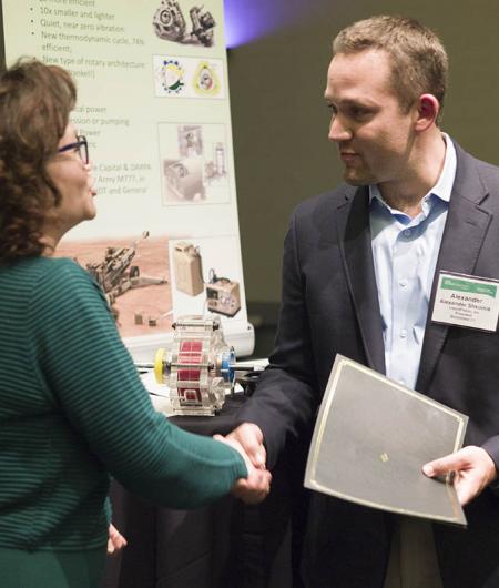 LiquidPiston CEO Alex Shkolnik accepts his company's award from AUVSI Executive Vice President Heather Lee. Photo: AUVSI