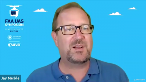 Jay Merkle speaks during the Post-Flight Debrief following the conclusion of Episode I of the 5th Annual FAA UAS Symposium - Remotely Piloted Edition. Screenshot courtesy of AUVSI