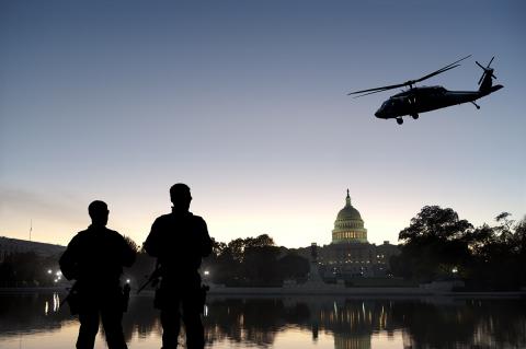 A stock photo of soldiers and a helicopter in front of the U.S. Capitol.